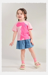 Detail of pink t-shirt with animal print and blue pleated denim shorts for girls