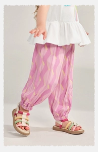 Detail of toddler girls breathable pink mosquito pants with yellow abstract print and sandals