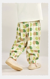 Detail view of children's breathable mosquito pants with green geometric prints and cuffs