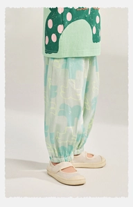Detail of mint green breathable cotton T-shirt and printed joggers for children summer wear