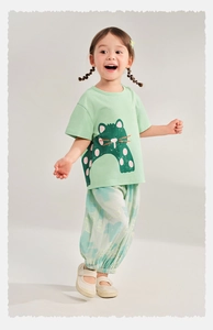 Detail of breathable summer kids outfit featuring printed mosquito pants and a green tee