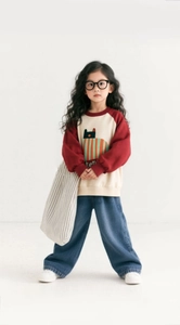 Detail of girls modern casual outfit with raglan sweatshirt and wide leg denim pants