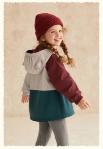 Detail of kids hooded jacket featuring contrast color panels and cute decorative ears