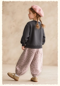 Detail of pink floral toddler joggers paired with a dark grey cotton sweatshirt