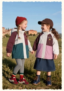 Outdoor shot of two girls wearing color-block hooded jackets with high-waist skirts