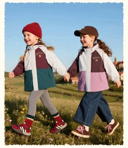 Detail of color-block windproof hooded jackets for girls featuring premium stitching