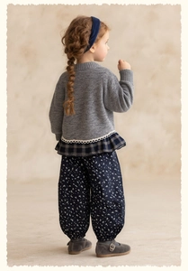 Detail of girls vintage knit sweater with blue floral bloomers and lace trim edge