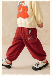 Detail of toddler corduroy pants with apple-shaped pocket and rib cuffs for autumn