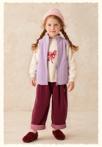Detailed look at purple fleece vest with white floral sweater and corduroy trousers set
