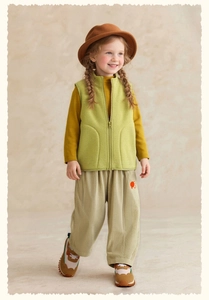 Detail of girls polar fleece vest in light green with matching autumn outfit set