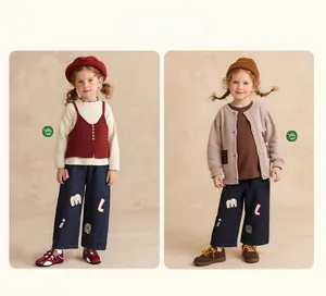Retro style kids casual outfit featuring knit vests and embroidered denim trousers