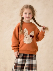 Cute bunny applique sweatshirt in warm orange paired with classic plaid wide-leg trousers