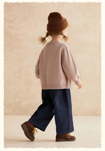 Rear view of pink knit sweater with ribbed cuffs and matching casual trousers for girls