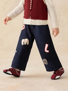 Girls dark blue wide-leg jeans with colorful alphabet patches and retro polka dot details