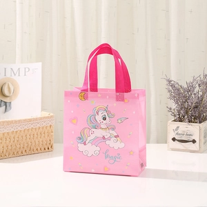 Pink non-woven gift bag featuring a colorful unicorn print and magic lettering detail