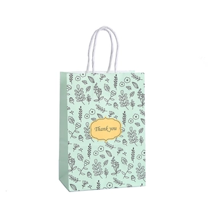 Mint green floral paper gift bag with Thank You tag and white rope handles