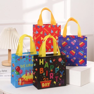 Colorful non-woven Happy Birthday gift bags with glossy finish and durable ribbon handles
