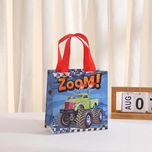 Detail of cartoon monster truck gift bag with vibrant blue finish and red handles