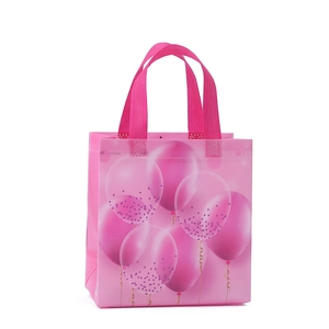 Pink non-woven gift bag featuring festive balloon prints and durable top handles