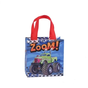 Blue non-woven gift bag with monster truck design and red handles for kids party