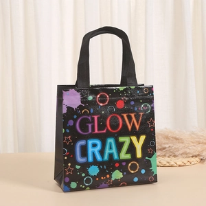 Detail of black non-woven gift bag with vibrant GLOW CRAZY neon text and star patterns