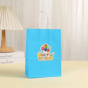 Blue kraft paper gift bag with white rope handles and colorful Happy Birthday patterns
