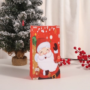 Christmas kraft paper gift bag featuring festive red Santa Claus design with snowflakes