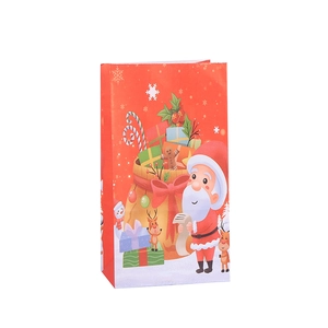 Christmas paper gift bag featuring festive Santa Claus and reindeer print in bright red color