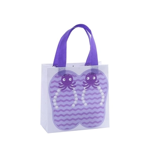 White non-woven gift bag with purple octopus pattern and matching handles