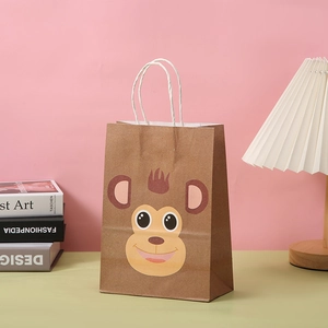 Detail of cartoon monkey kraft paper gift bag with white rope handles and cute design