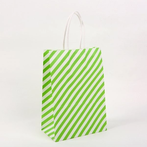 Detail of green and white diagonal striped paper gift bag with white twisted handles