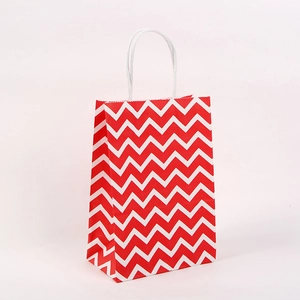 Detail of red and white wave pattern gift bag with white twisted rope handles