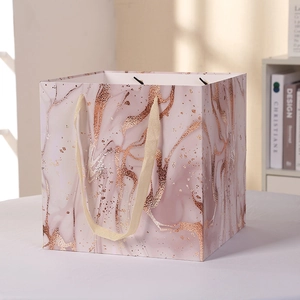 Pink marble pattern gift paper bag with rose gold foil and ribbon handles for shopping