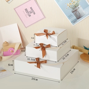 Three-piece set of white square gift boxes with brown silk bows and dimensions shown