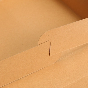 Macro detail of locking tab closure on a brown kraft paper gift box structure