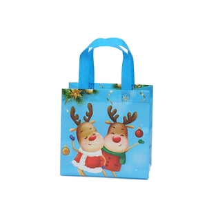 Blue Christmas non-woven gift bag featuring cartoon reindeer and golden holiday star prints