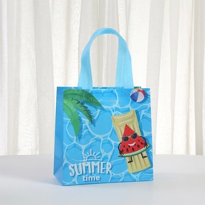 Detail of waterproof blue non-woven gift bag with summer beach prints and palm leaf motifs
