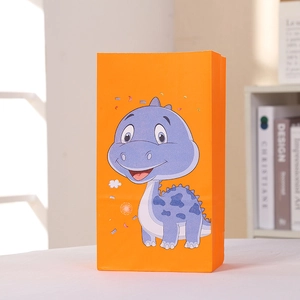 Sac cadeau en papier orange avec un dinosaure violet de dessin animé et des confettis