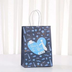 Detail view of Father's Day paper gift bag with blue tie motifs and heart pattern