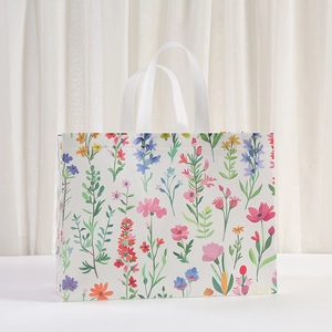 Waterproof non-woven gift bag featuring vibrant floral patterns and white webbed handles