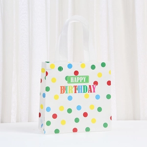 White non-woven birthday gift bag with colorful polka dots and Happy Birthday text