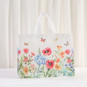 Floral non-woven gift bag with colorful flowers and butterfly prints on a white background
