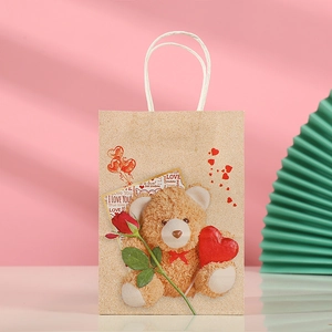 Detail view of kraft paper gift bag featuring a 3D-style bear with red hearts and rose