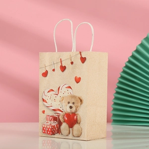 Detail of kraft gift bag featuring a teddy bear and heart motif with white rope handles