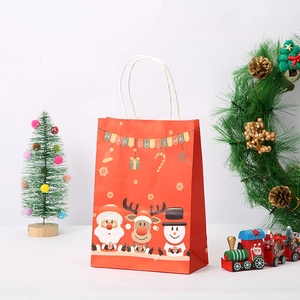 Detail of red Christmas paper gift bag with Santa Claus, reindeer and snowman prints
