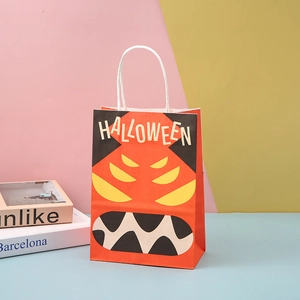 Orange Halloween kraft paper gift bag with monster face design and white string handles