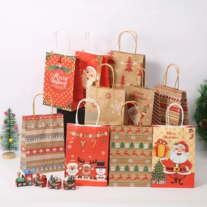Detail view of assorted Christmas kraft paper gift bags with reindeer and Santa prints