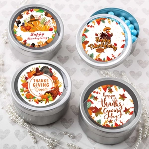 Detail of round Thanksgiving stickers on silver tins with turkey and pumpkin designs