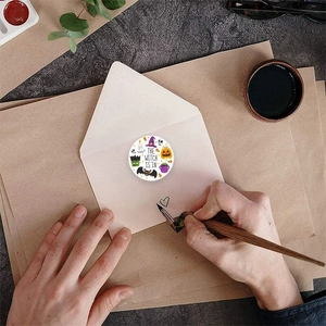 Halloween pumpkin and bat circular stickers on vintage envelope for candy bag sealing