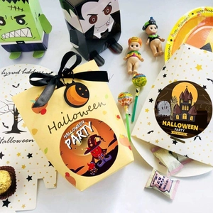 Halloween gift bags with pumpkin and castle designs, black ribbon handles and tags